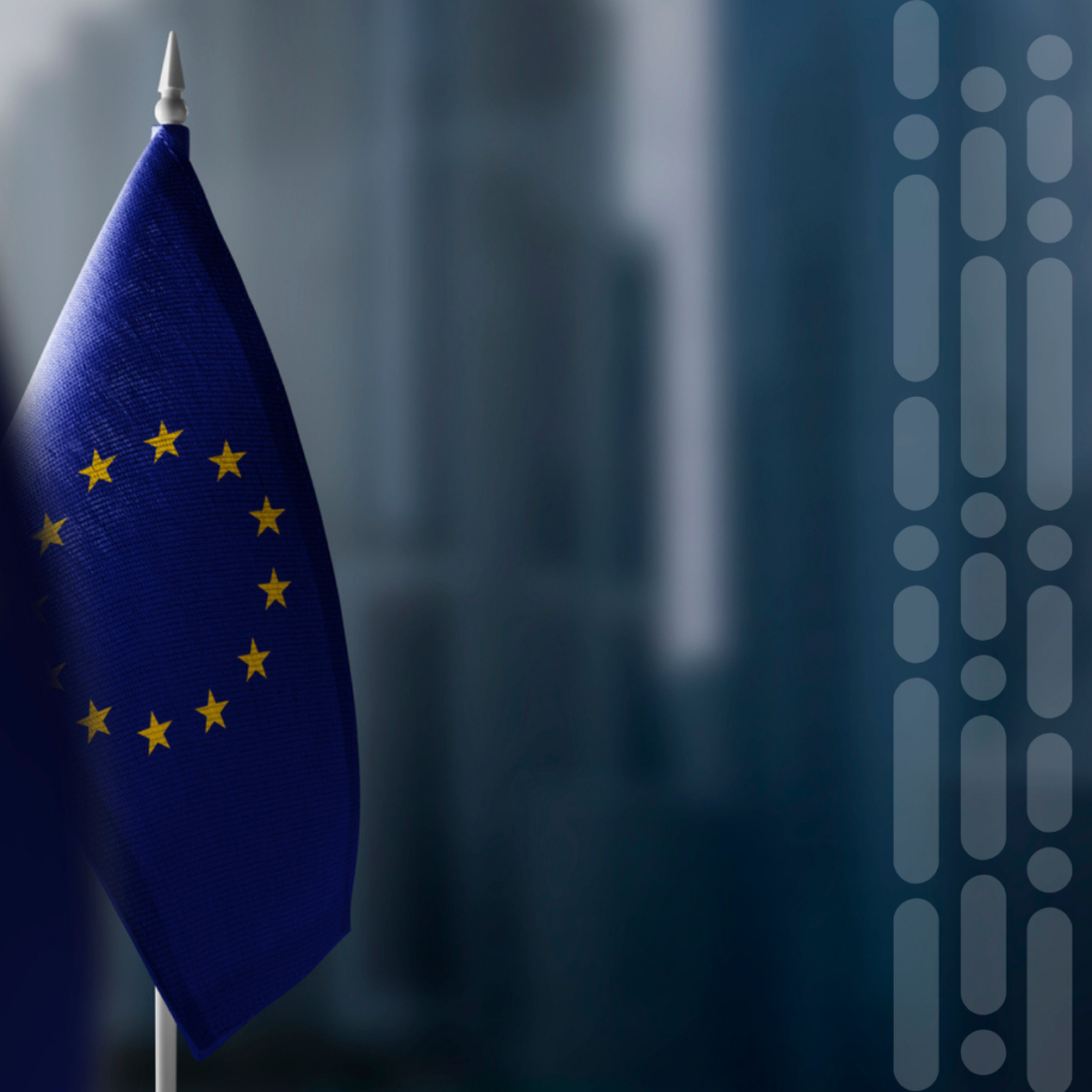 Close-up of the European Union flag on a flagpole, blue field with gold stars near the left edge.